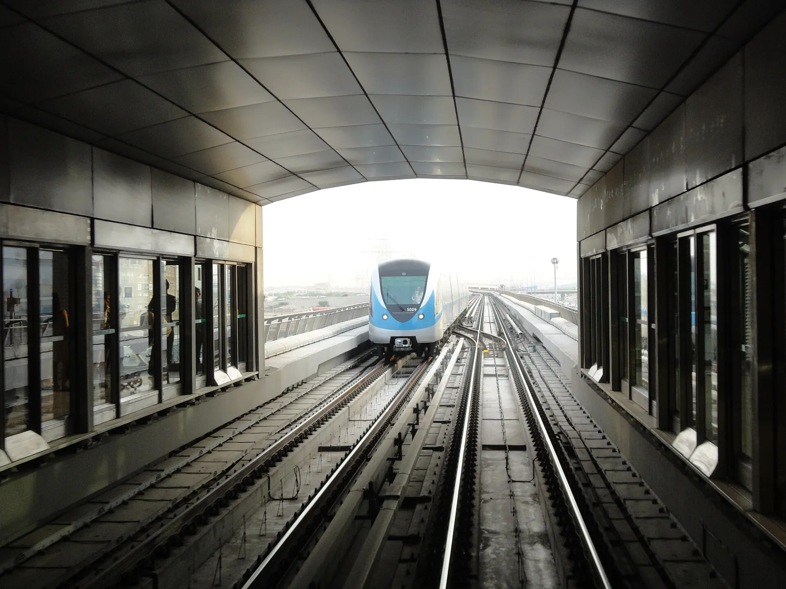Dubai Metro train arriving at an elevated Red Line station