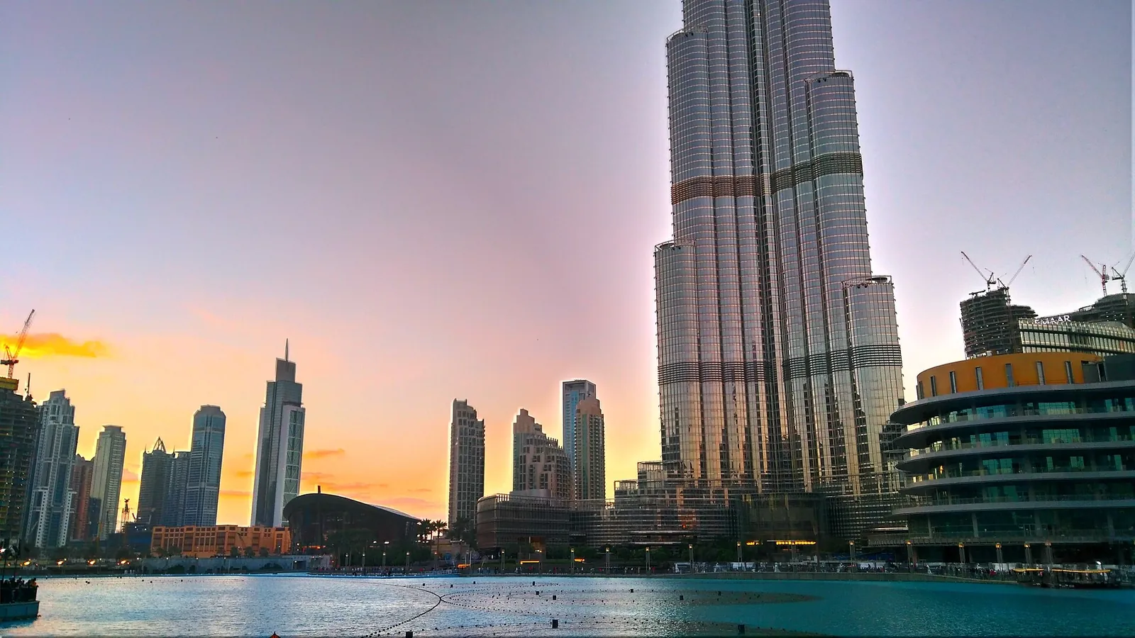 Burj Khalifa rising above Burj Lake, home of the Dubai Fountain, at dusk