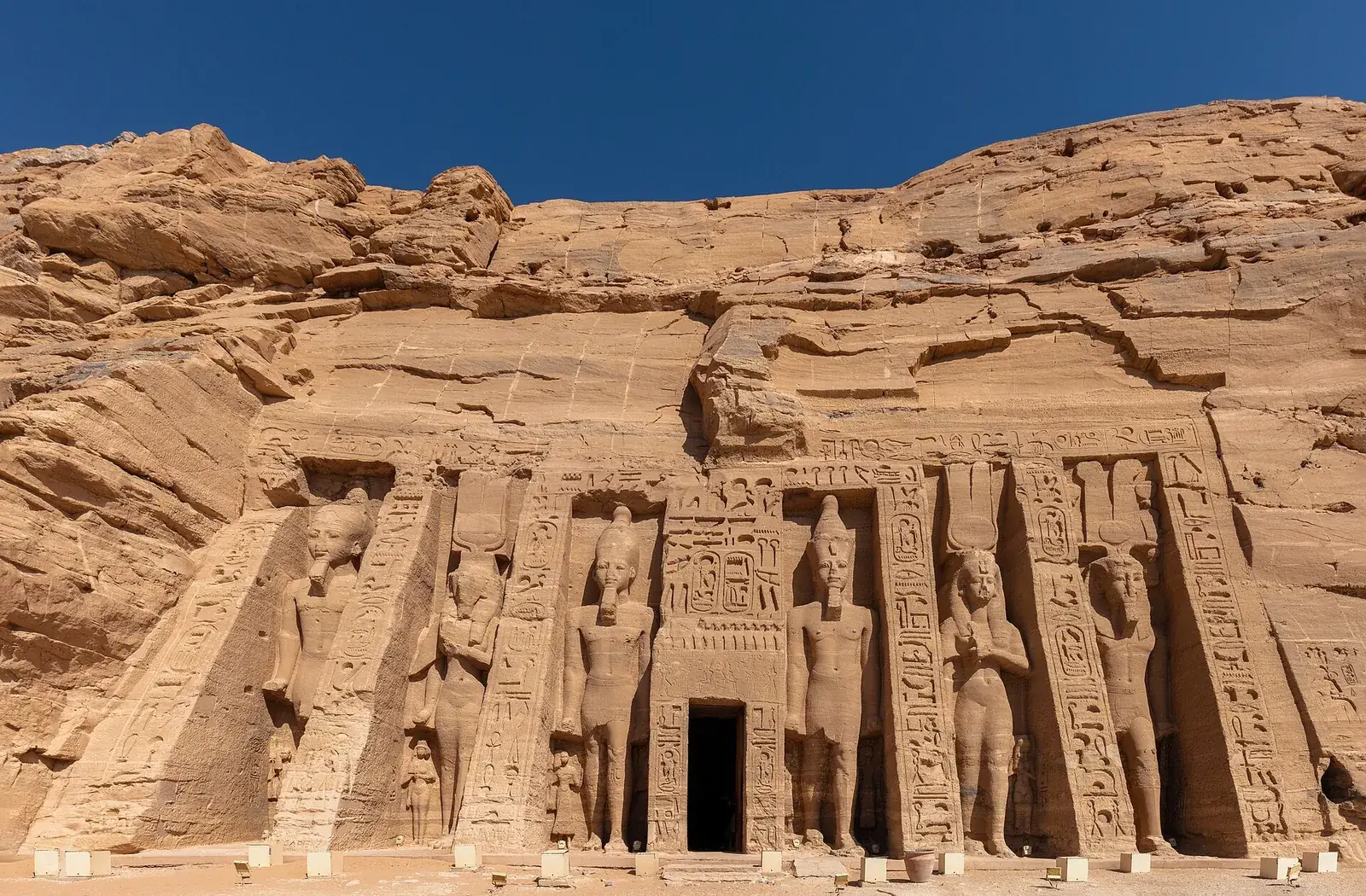 Standing statues of Ramesses II and Queen Nefertari on the facade of the Small Temple at Abu Simbel, Egypt