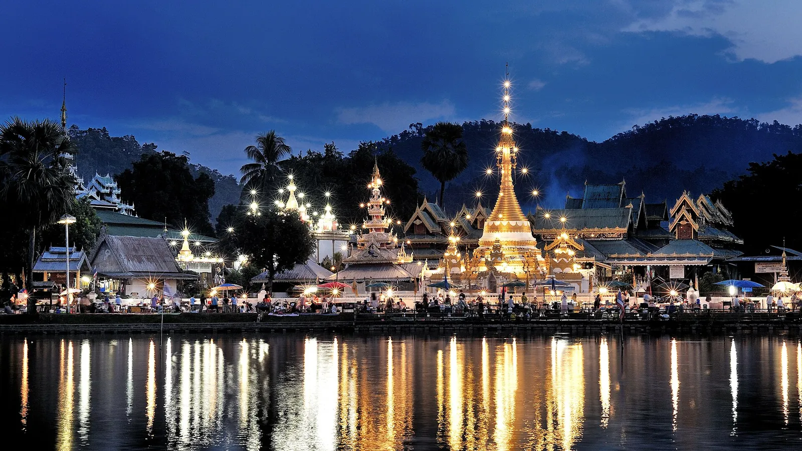 Burmese-style temples of Wat Chong Klang reflected in Chong Kham Lake, Mae Hong Son