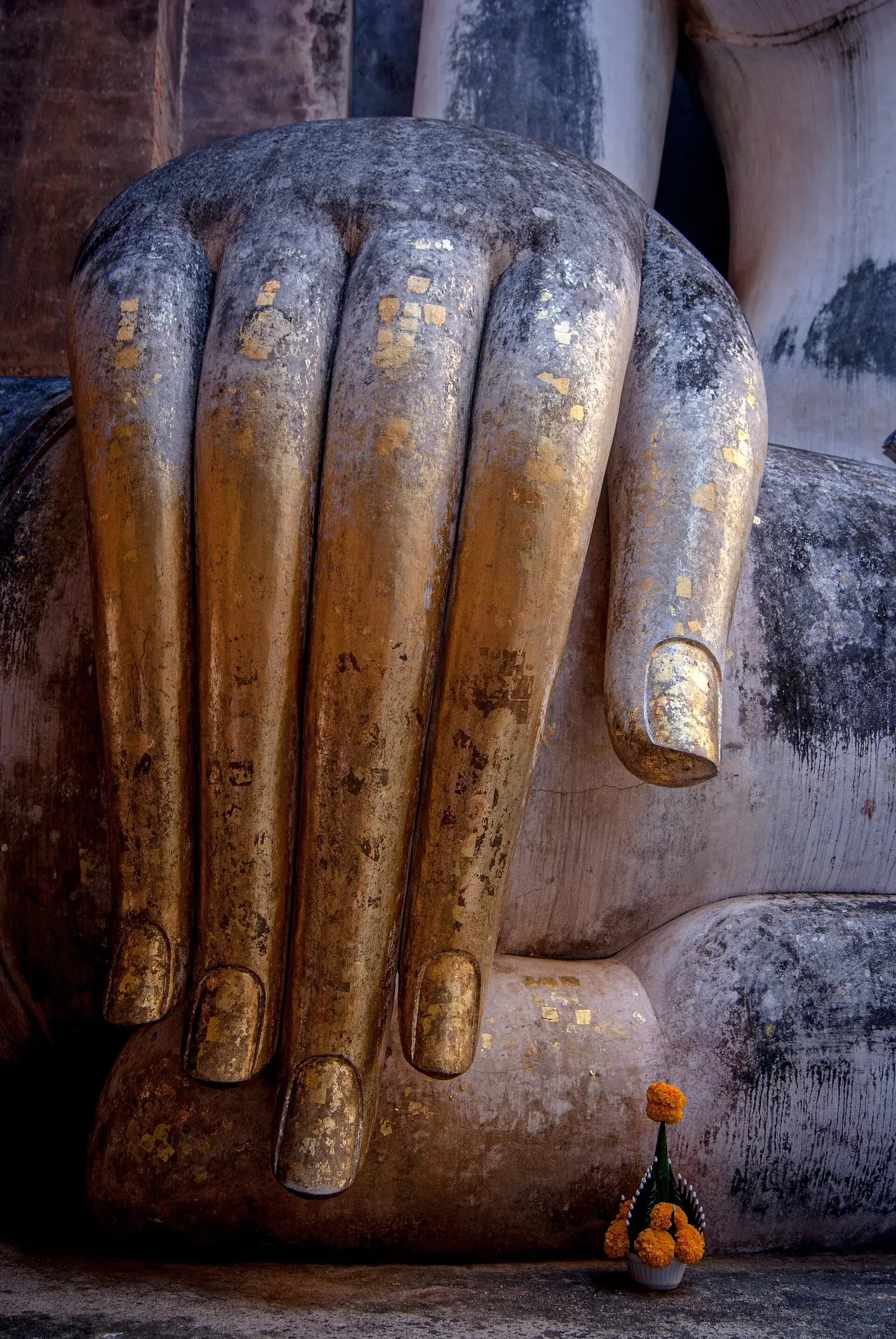 The gilded fingers of the huge seated Buddha at Wat Si Chum in Sukhothai