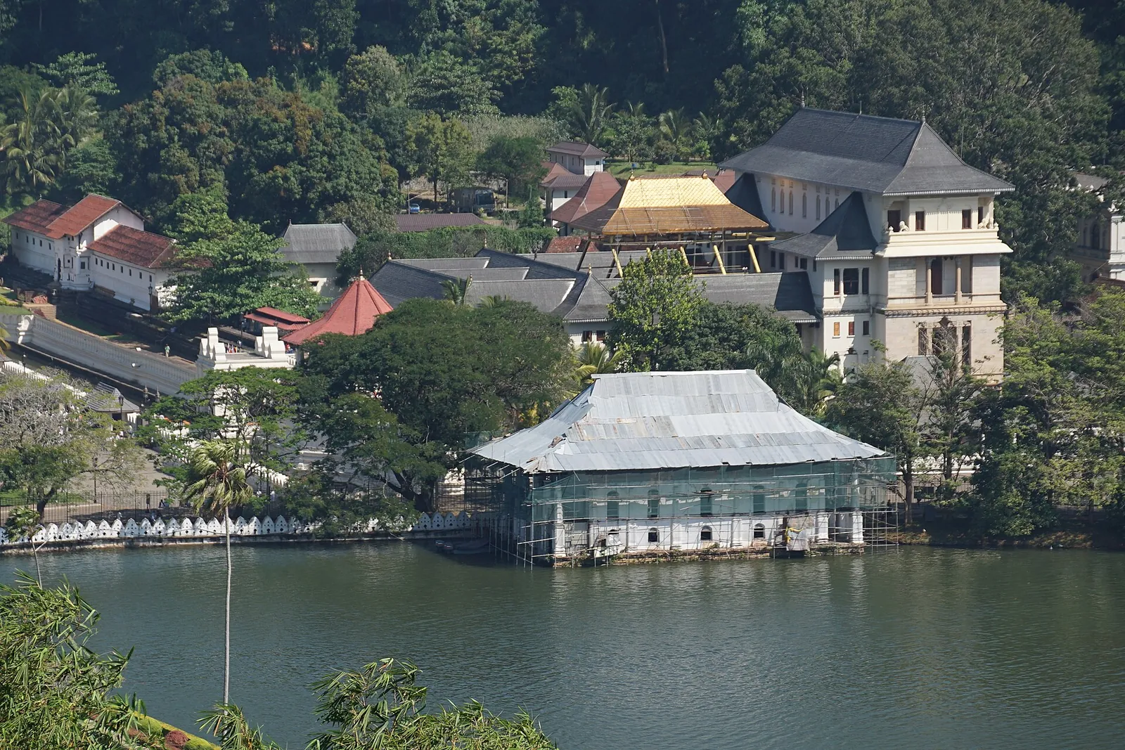 The Temple of the Sacred Tooth Relic on the shore of Kandy Lake, with the town's hills behind