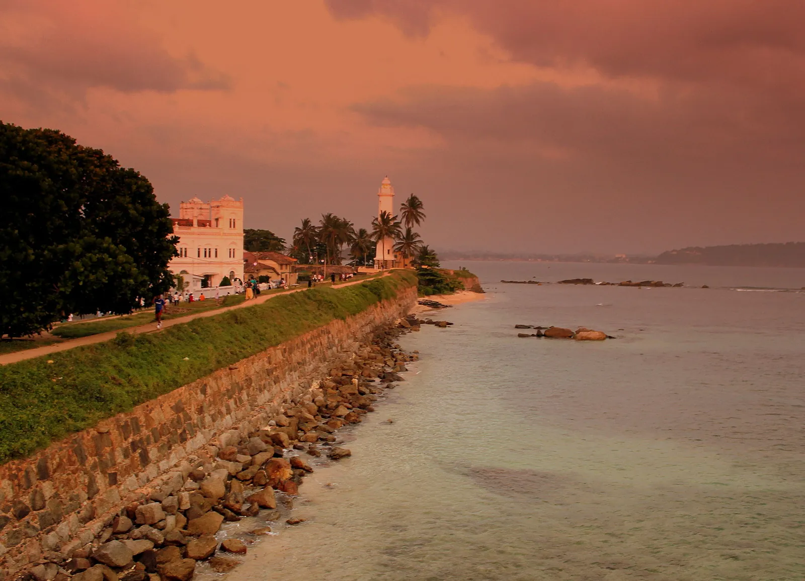 The old ramparts of Galle Fort above the sea in warm evening light